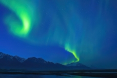 Aurora Borealis over Knik River and Chugach Mountains