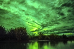Aurora lit clouds reflecting in Nenana River